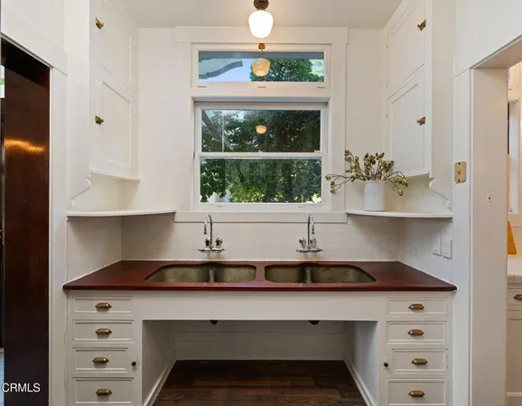 a kitchen with granite countertop a sink and cabinets