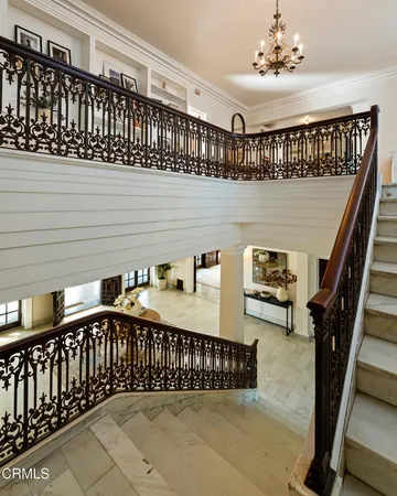 a dining room with wooden floor and stairs