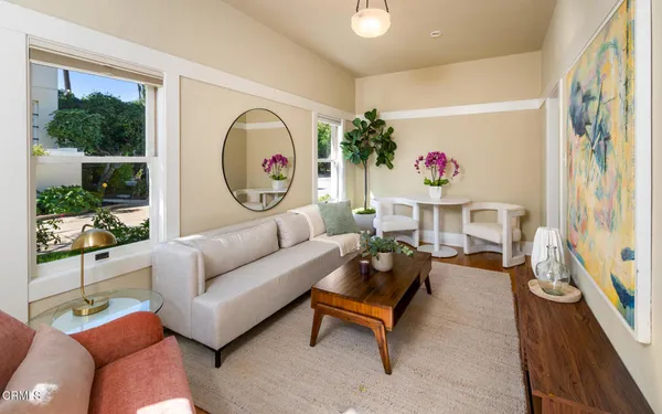 a kitchen with white cabinets a sink dishwasher and a stove with wooden floor