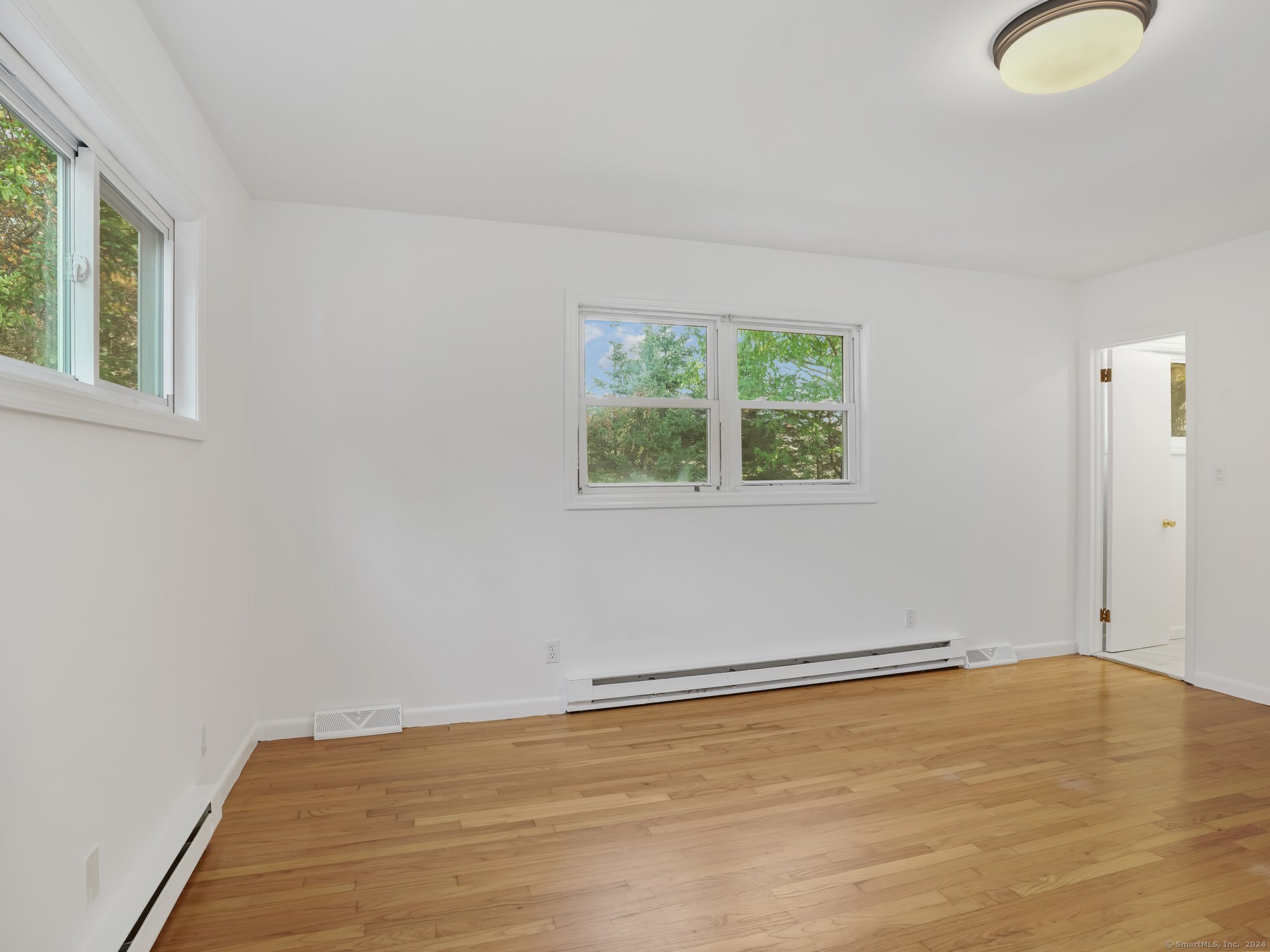 488 Sport Hill Road Easton, CT 06612 - Photo 15 of 32 a view of a room with wooden floor and windows