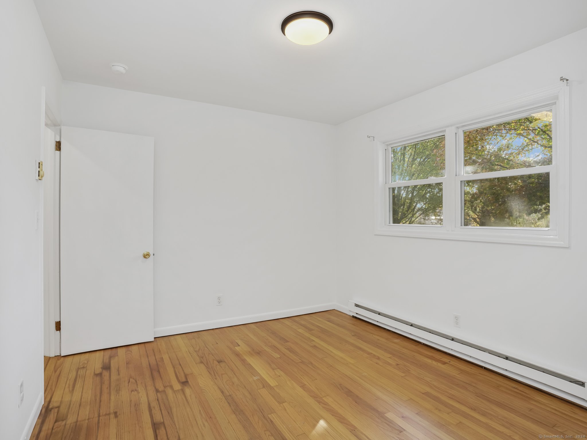488 Sport Hill Road Easton, CT 06612 - Photo 19 of 32 a view of empty room with wooden floor and fan