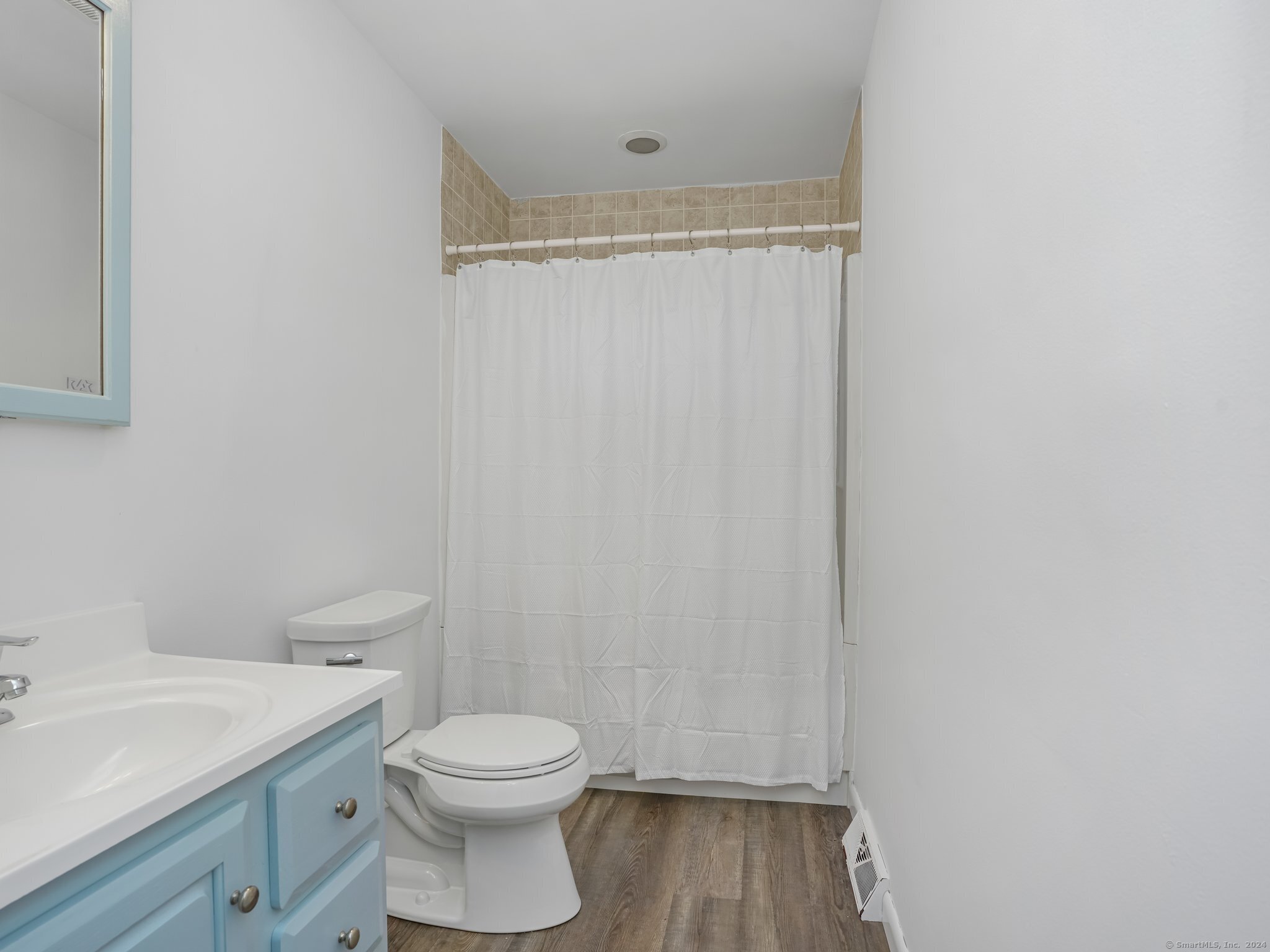 488 Sport Hill Road Easton, CT 06612 - Photo 20 of 32 a bathroom with a toilet a sink and wooden floor