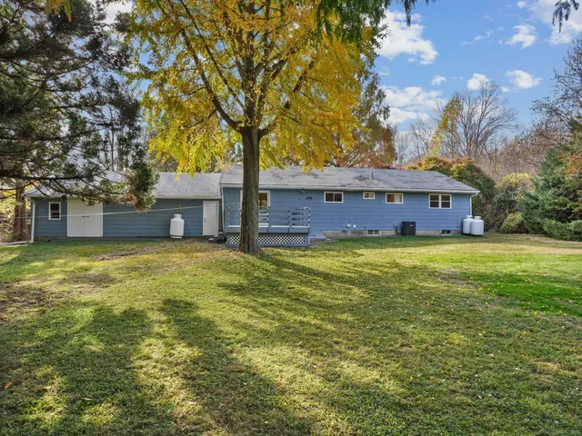 a front view of house with yard and trees