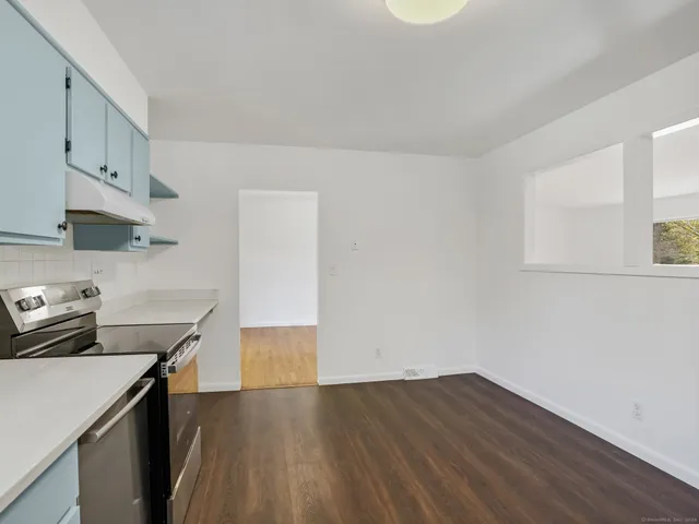 a kitchen with wooden floor and sink