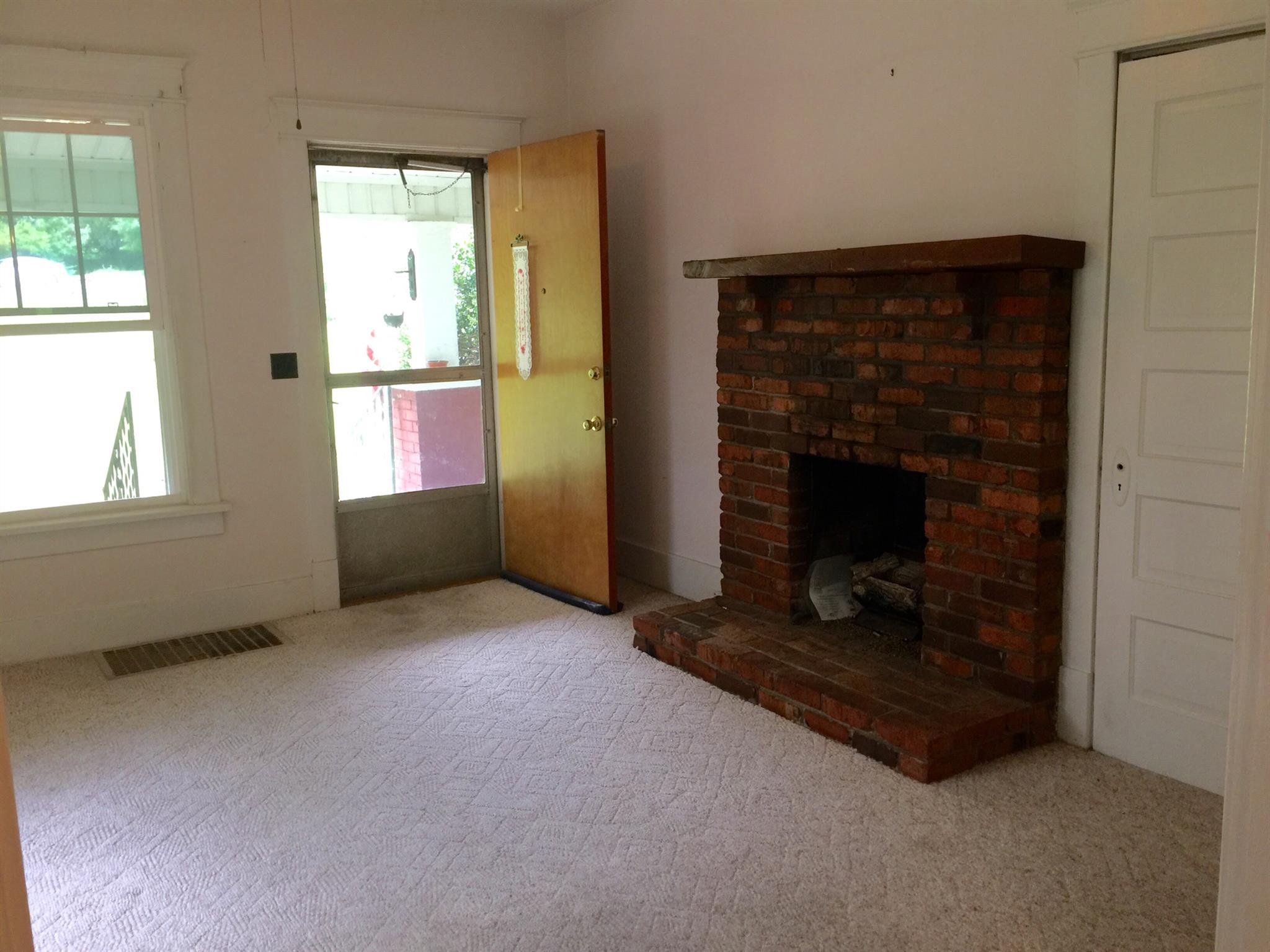 128 East Campbell Road Madison, TN 37115 - Photo 5 of 26 Living room with great windows, fireplace and hardwood under carpet.