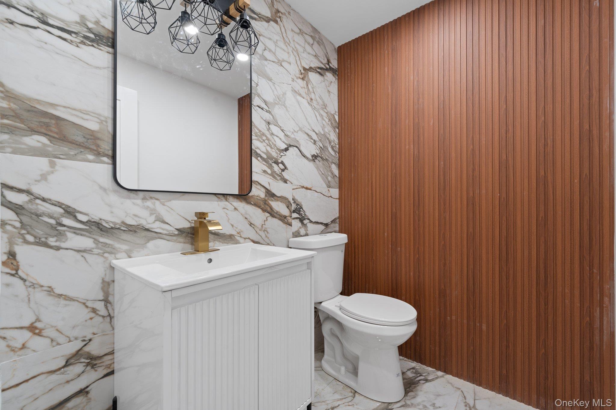 614 Madison Street Brooklyn, NY 11221 - Photo 12 of 14 a bathroom with a toilet sink and mirror
