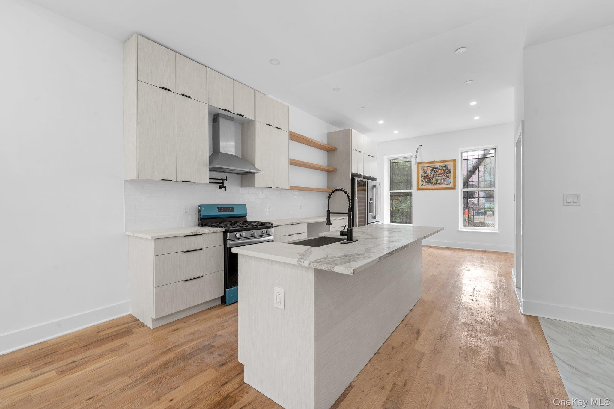 614 Madison Street Brooklyn, NY 11221 - Photo 7 of 14 a kitchen with stainless steel appliances granite countertop a stove and a sink