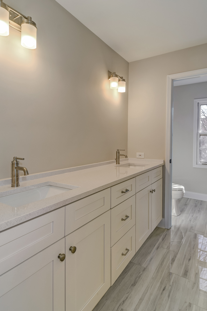 2116 Keim Road Naperville, IL 60565 - Photo 16 of 18 a bathroom with a double vanity sink a toilet and a mirror