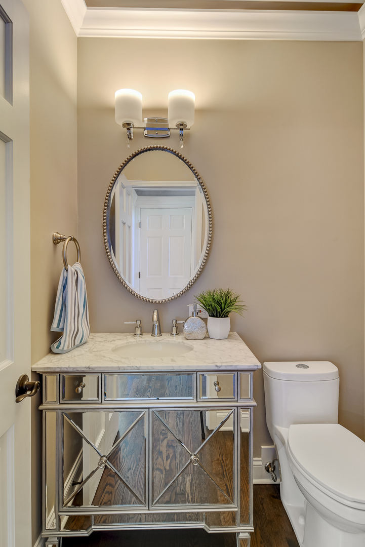 2116 Keim Road Naperville, IL 60565 - Photo 7 of 18 a bathroom with a toilet a sink and a mirror