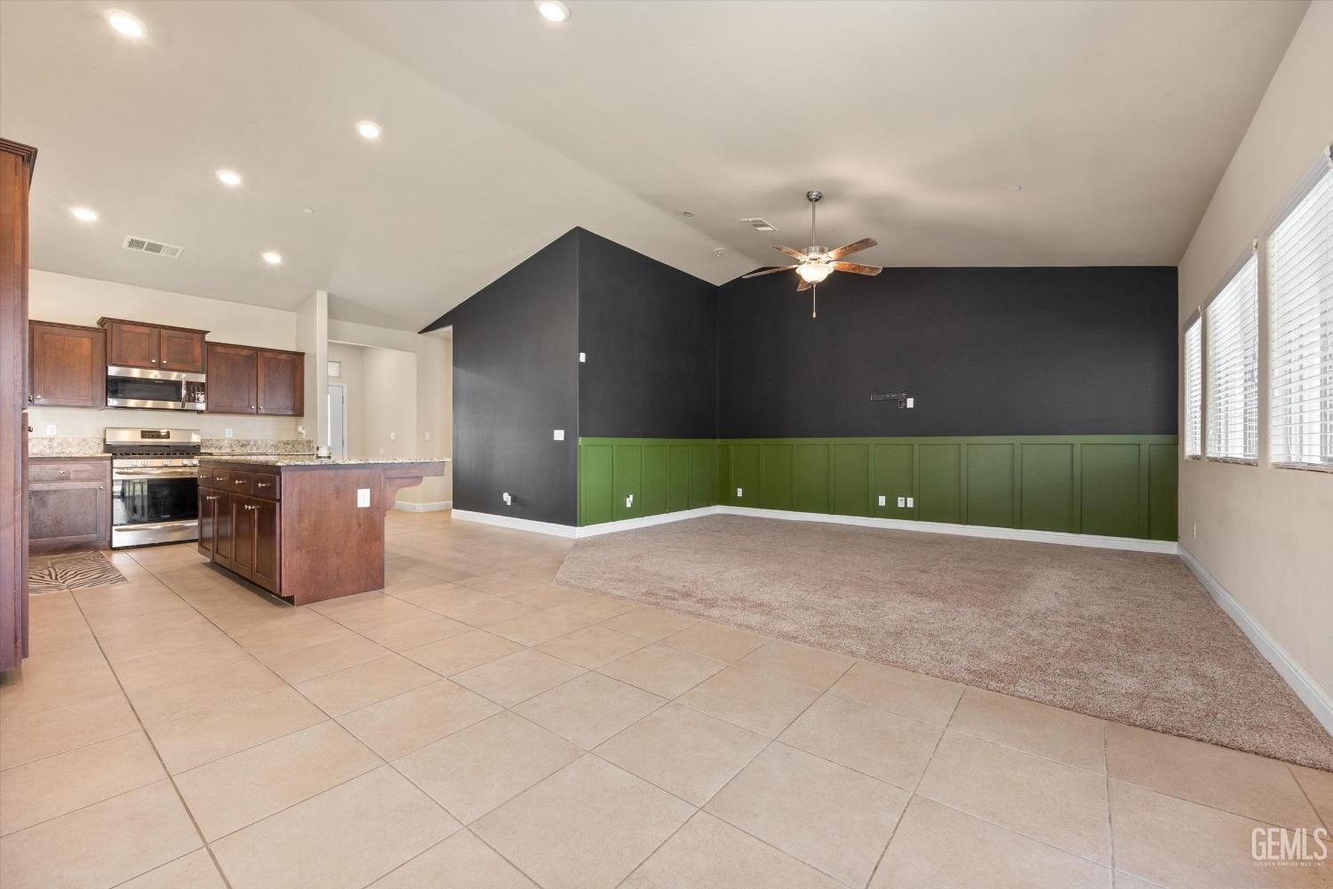Undisclosed Address Shafter, CA 93263 - Photo 12 of 29 a kitchen with kitchen island a stove top oven and cabinets