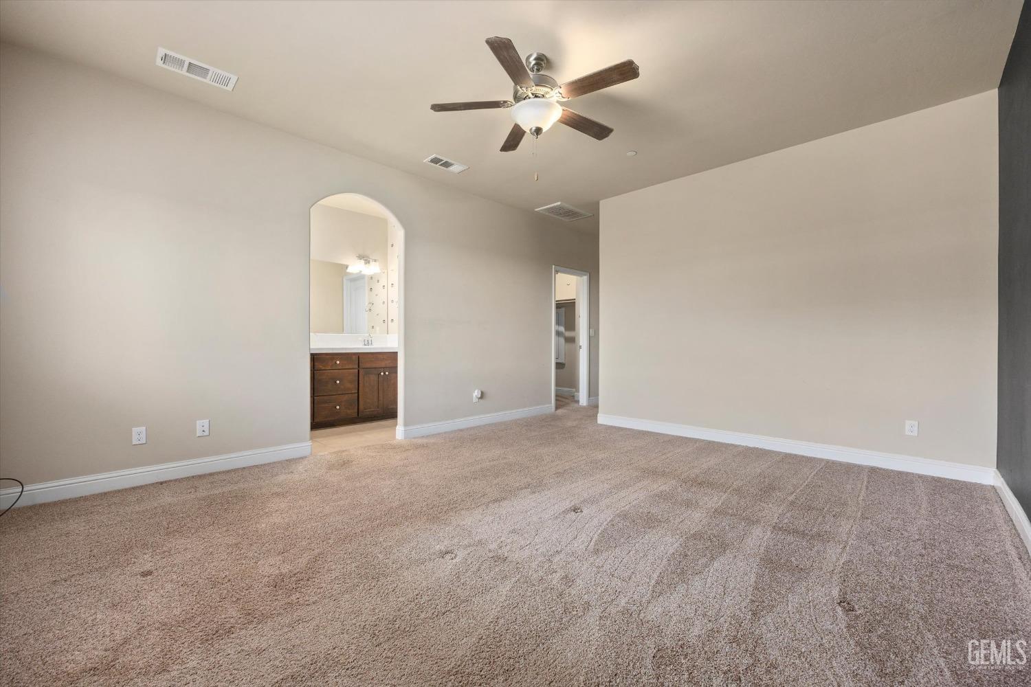 Undisclosed Address Shafter, CA 93263 - Photo 14 of 29 an empty room with chandelier fan and windows