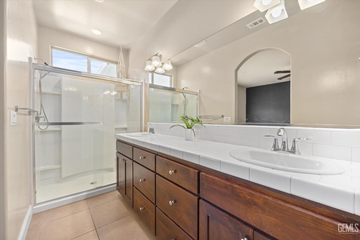 Undisclosed Address Shafter, CA 93263 - Photo 15 of 29 a bathroom with a double vanity sink and mirror