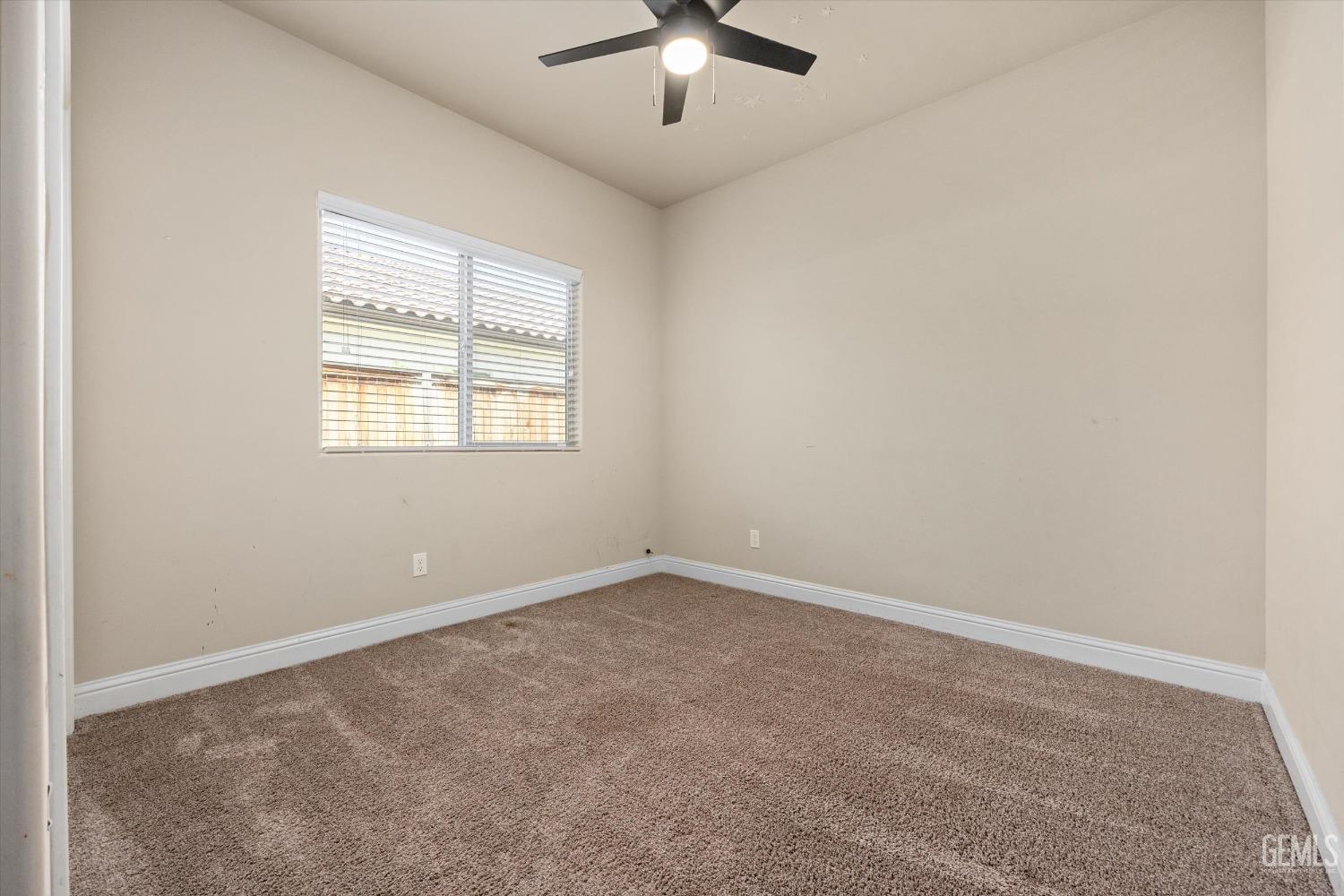 Undisclosed Address Shafter, CA 93263 - Photo 17 of 29 an empty room with chandelier fan and windows
