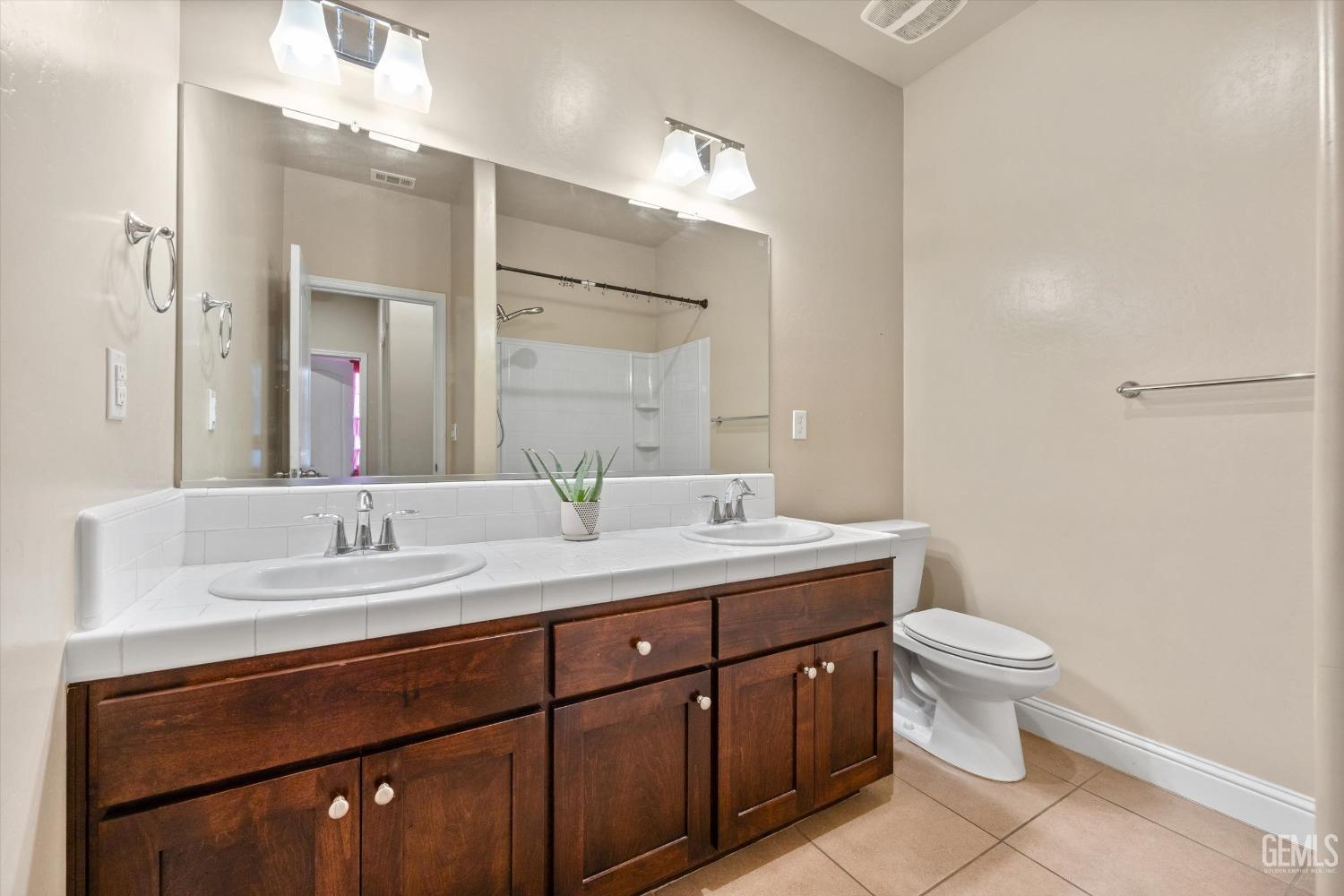 Undisclosed Address Shafter, CA 93263 - Photo 19 of 29 a bathroom with a granite countertop sink a toilet and a mirror
