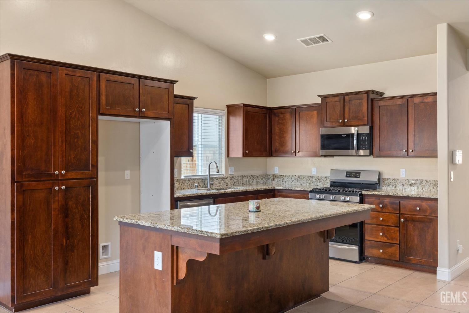 Undisclosed Address Shafter, CA 93263 - Photo 6 of 29 a kitchen with stainless steel appliances granite countertop a refrigerator stove a sink and dishwasher