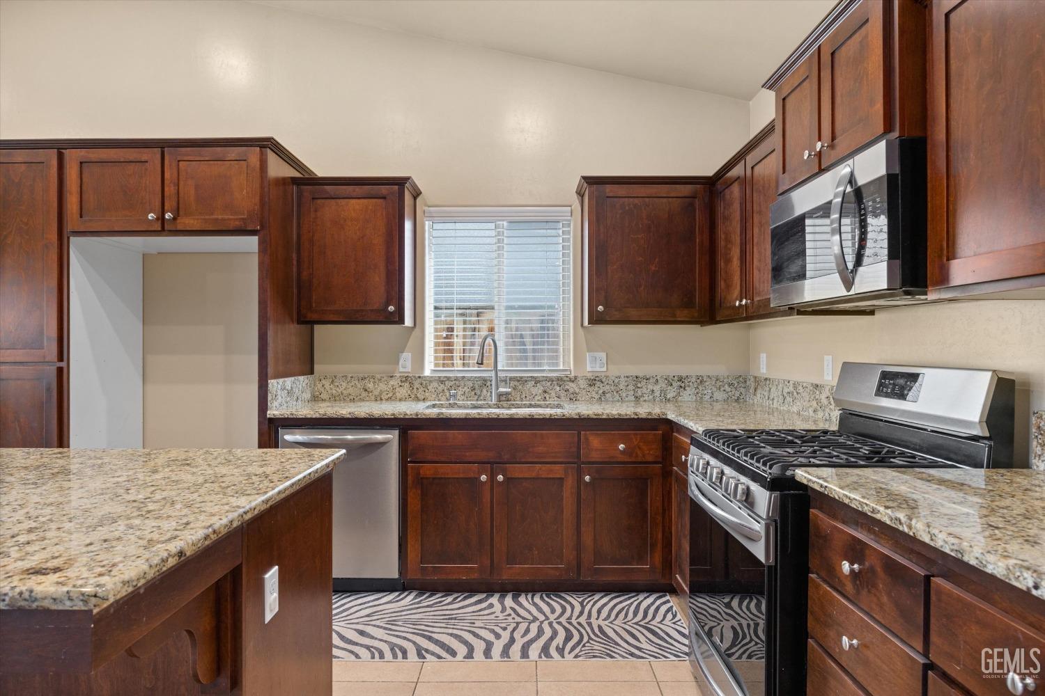 Undisclosed Address Shafter, CA 93263 - Photo 7 of 29 a kitchen with stainless steel appliances granite countertop a sink stove and refrigerator