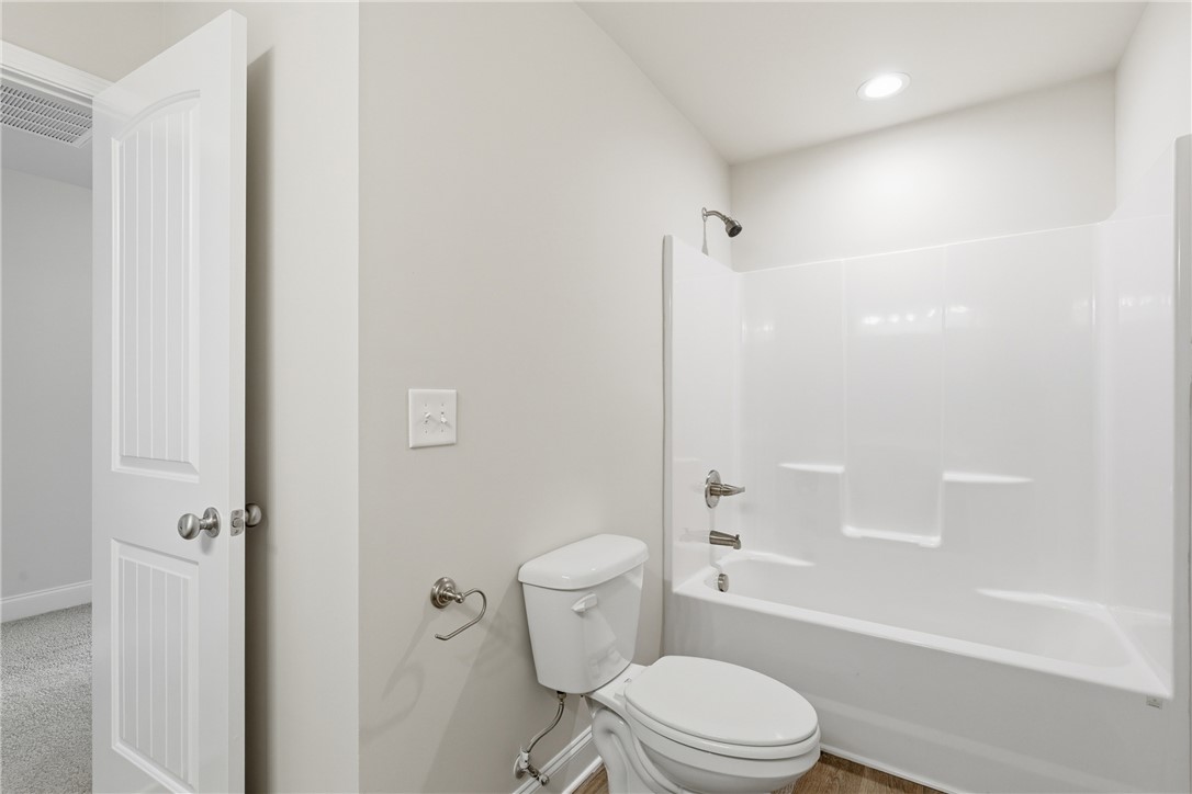 116 Ventura Street Anderson, SC 29621 - Photo 21 of 27 An inviting bathroom displays a modern tub shower surround and recessed lighting.