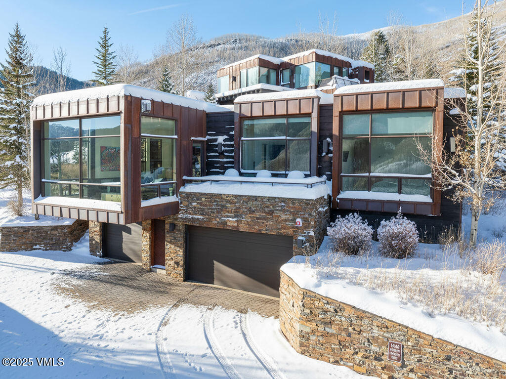 1449 Buffehr Creek Road Vail, CO 81657 - Photo 3 of 41 a front view of a house with garden