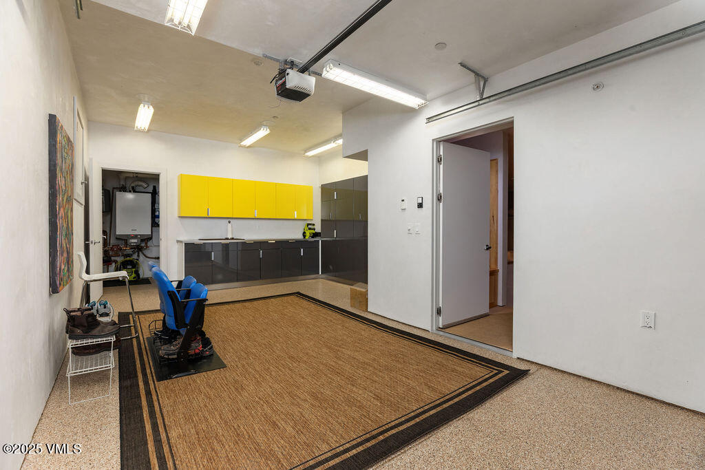 1449 Buffehr Creek Road Vail, CO 81657 - Photo 34 of 41 a room with gym equipment and a flat screen tv