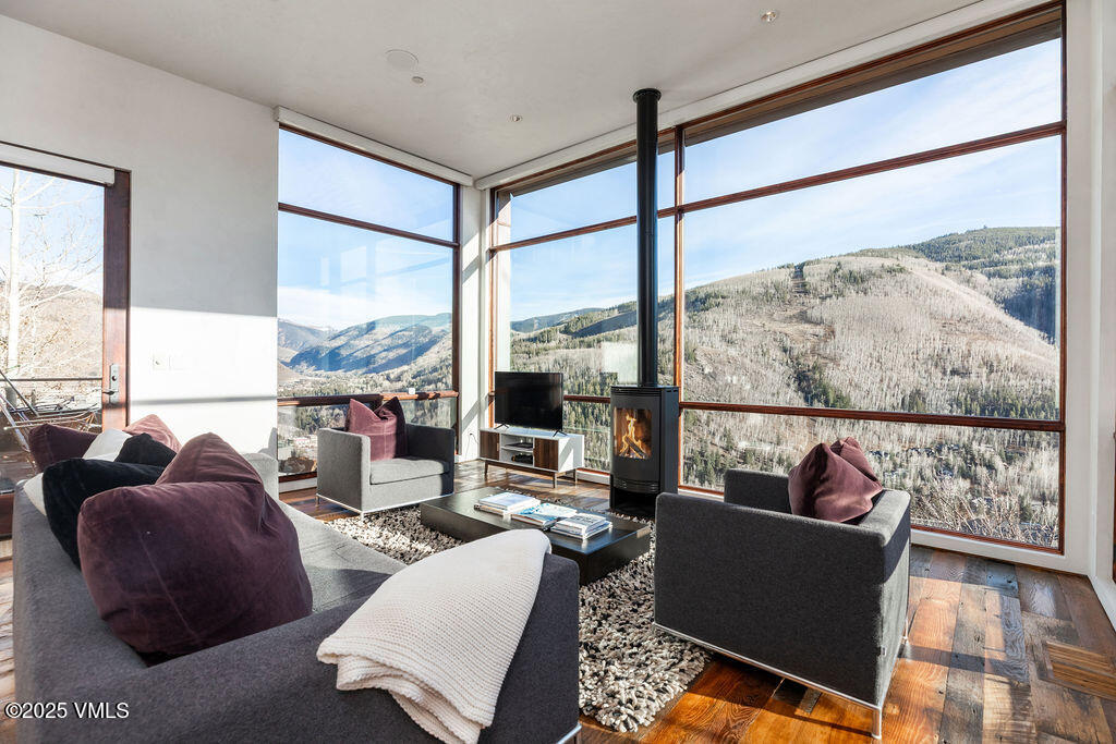 1449 Buffehr Creek Road Vail, CO 81657 - Photo 4 of 41 a living room with furniture and a floor to ceiling window