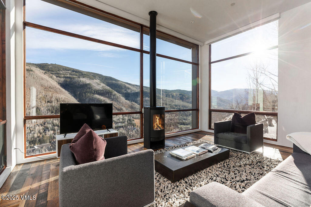 1449 Buffehr Creek Road Vail, CO 81657 - Photo 5 of 41 a living room with furniture and a floor to ceiling window