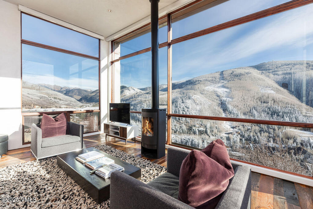 1449 Buffehr Creek Road Vail, CO 81657 - Photo 6 of 41 a living room with furniture and a floor to ceiling window
