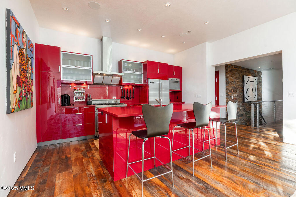 1449 Buffehr Creek Road Vail, CO 81657 - Photo 10 of 41 a living room with lots of furniture and kitchen view