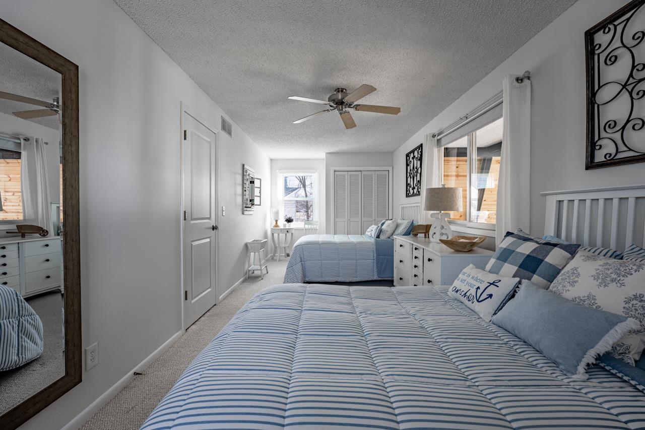 1435 Pier Drive Lake Summerset, IL 61019 - Photo 16 of 35 a spacious bedroom with a large bed and a chandelier