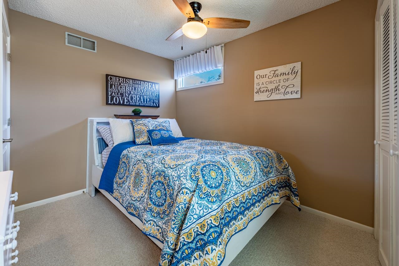 1435 Pier Drive Lake Summerset, IL 61019 - Photo 19 of 35 a bedroom with a bed and a chandelier