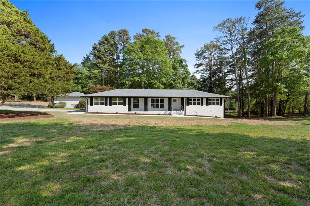 2604 Flat Shoals Road Southwest Conyers, GA 30094 - Photo 1 of 1 a house view with a garden space