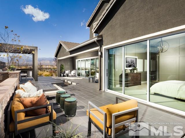 9520 Baldacci Court, Unit HOMESITE 33 Reno, NV 89521 - Photo 9 of 10 a outdoor living space with furniture and a fireplace