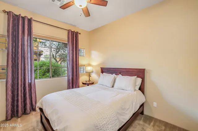 a bedroom with a large bed and a large window