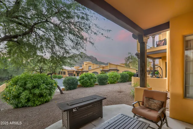 a view of balcony with furniture and a garden