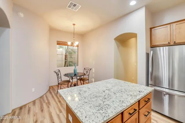 a kitchen with stainless steel appliances granite countertop sink refrigerator and microwave