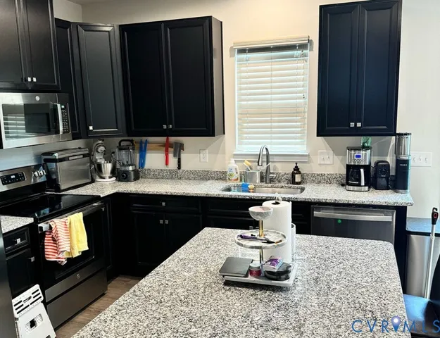 a kitchen with a sink stove and wooden cabinets