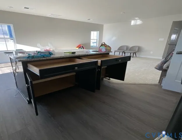 a room with table chairs and wooden floor