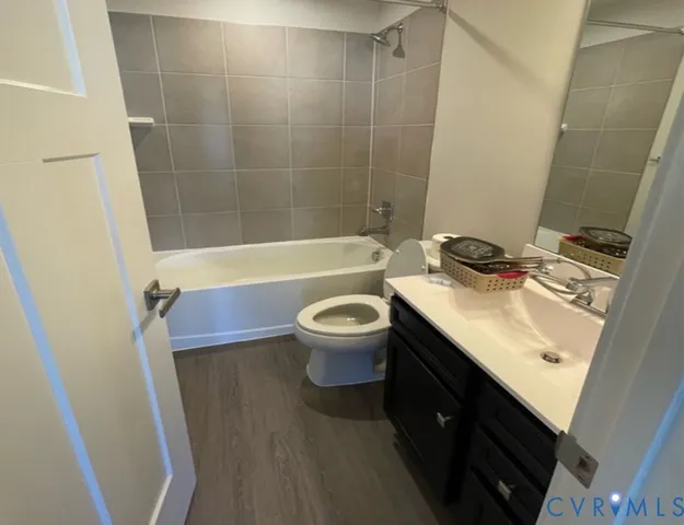 a bathroom with a sink a toilet a mirror and shower