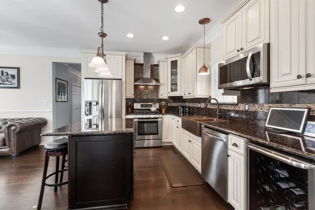 a kitchen with stainless steel appliances granite countertop a refrigerator a stove microwave and cabinets