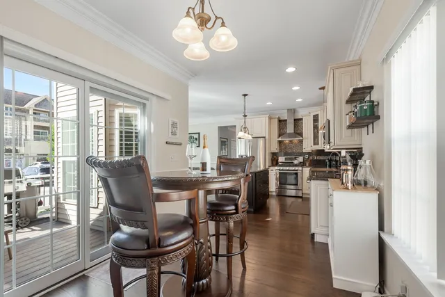 a view of a dining room with furniture large window and wooden floor