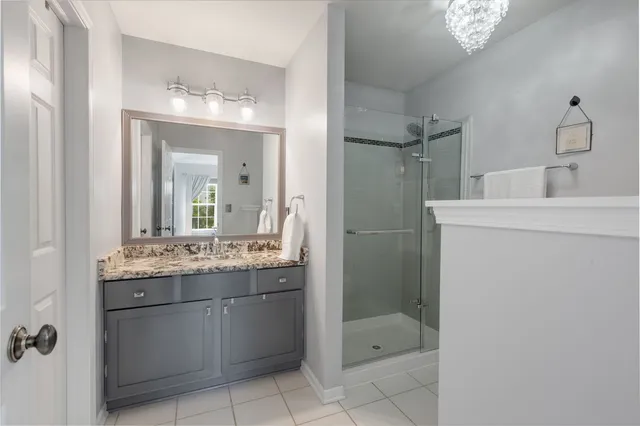 a bathroom with a shower sink and mirror