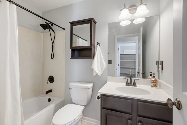 a bathroom with a sink toilet a mirror and shower