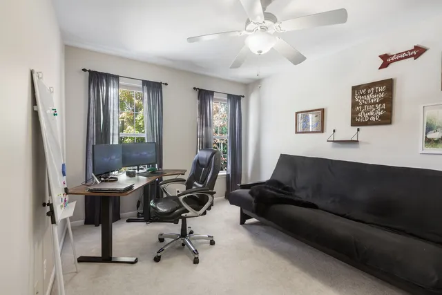 a view of a livingroom with workspace and a couch