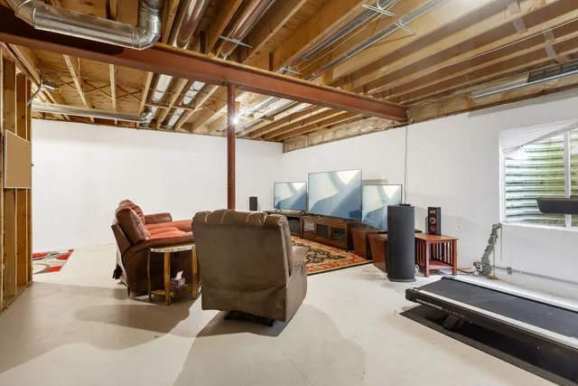 a roof deck with table and chairs