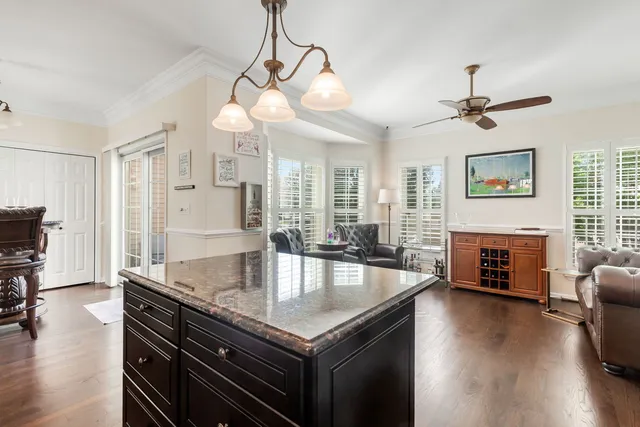 a open kitchen with stainless steel appliances granite countertop a stove kitchen island a refrigerator and a stove