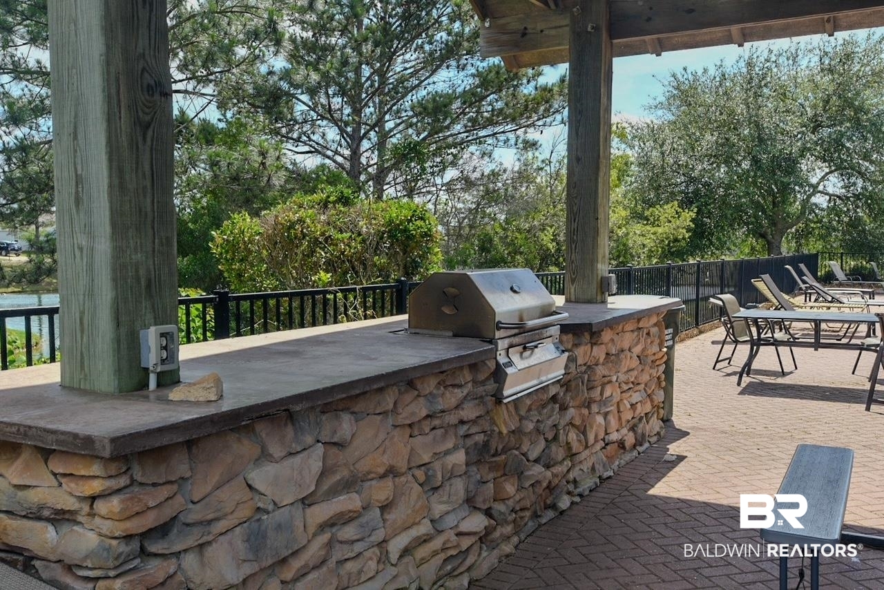 17430 Harding Drive Foley, AL 36535 - Photo 37 of 37 View of patio with an outdoor kitchen, grilling area, and fence