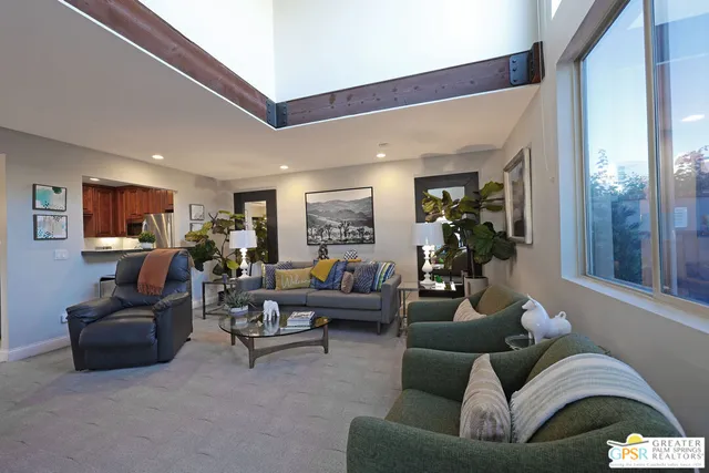 a living room with furniture and a potted plant