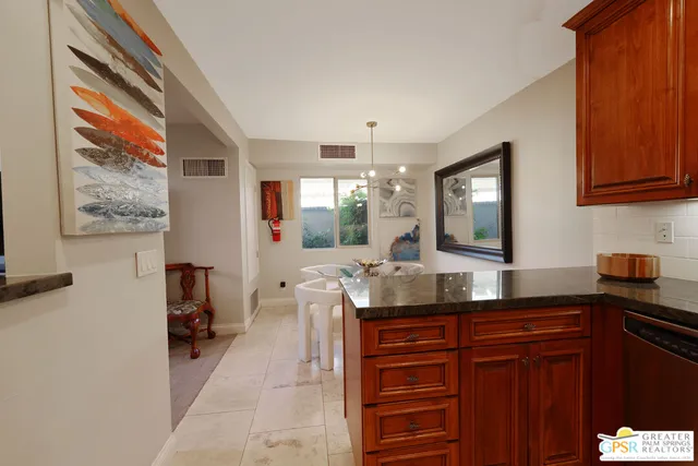 a kitchen with granite countertop a sink and a wooden cabinets