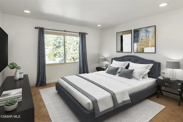 a bedroom with bed and window