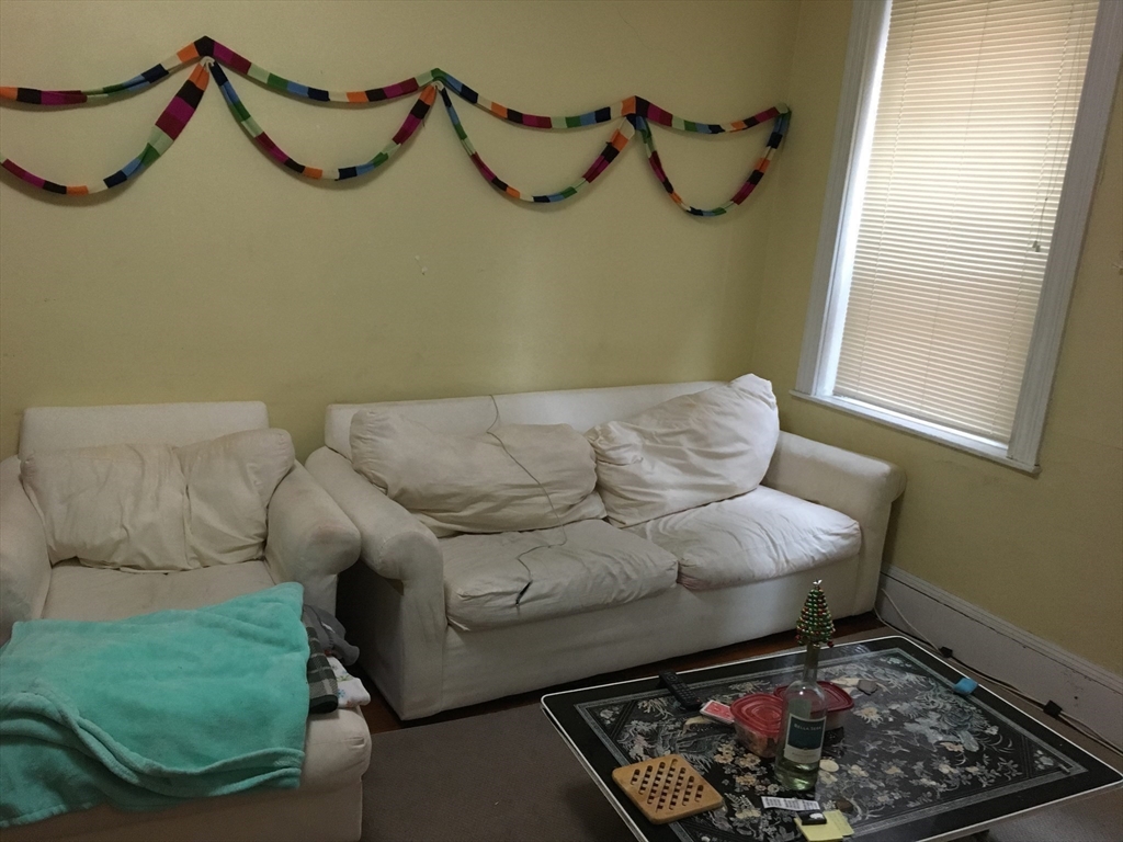 71 South Huntington Avenue, Unit 2 Boston, MA 02130 - Photo 8 of 15 a living room with furniture and a rug