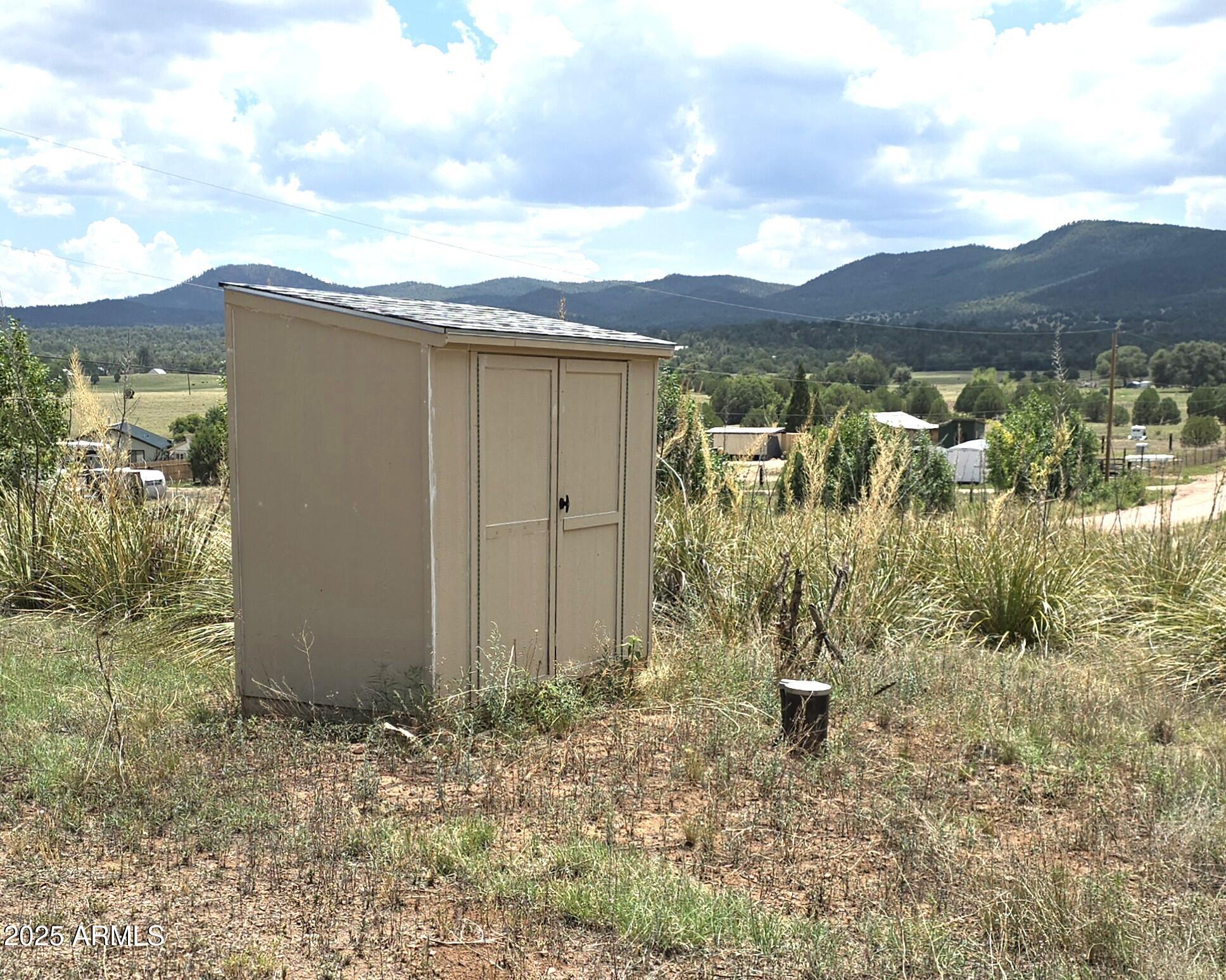 410-5 Rolling Hills Road, Unit 5 Young, AZ 85554 - Photo 1 of 4 a view of a house with a yard and mountain view in back